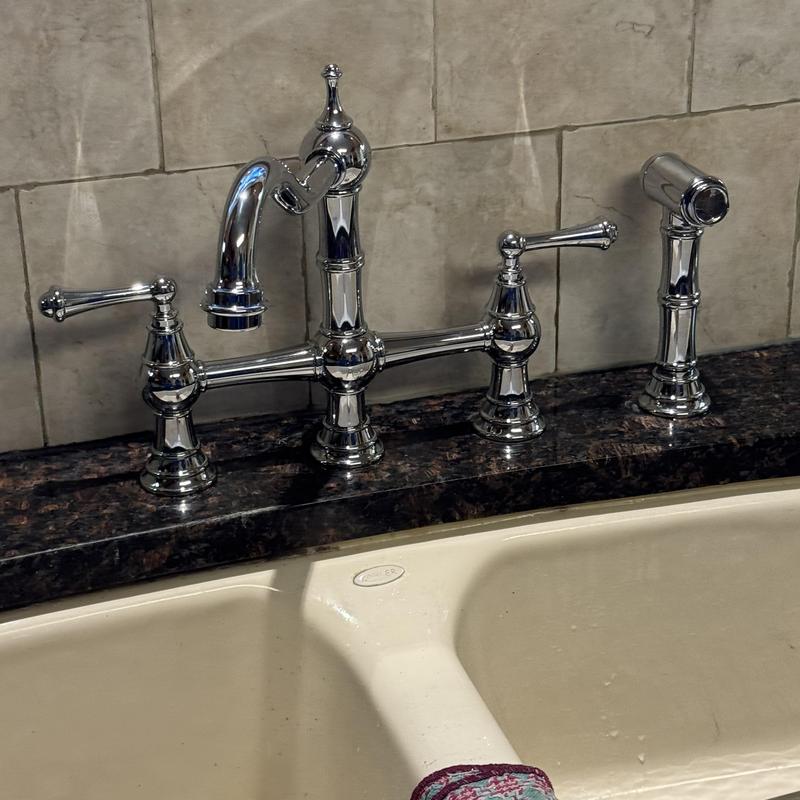 Kitchen sink faucet with sprayer on granite countertop Kitchen sink faucet with sprayer on granite countertop