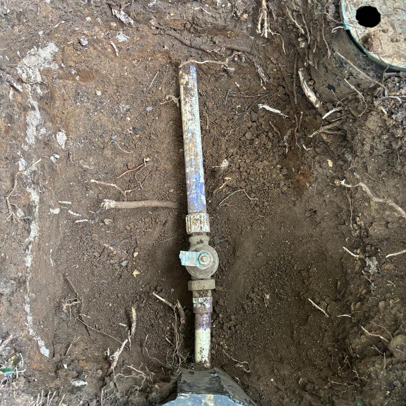 Main water line valve installed underground in soil trench Main water line valve installed underground in soil trench