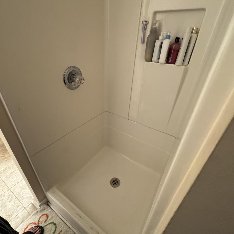 Fiberglass shower stall with sealed joints and patched door holes Fiberglass shower stall with sealed joints and patched door holes