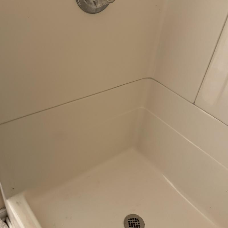 Fiberglass shower stall resealed with silicone joints Fiberglass shower stall resealed with silicone joints