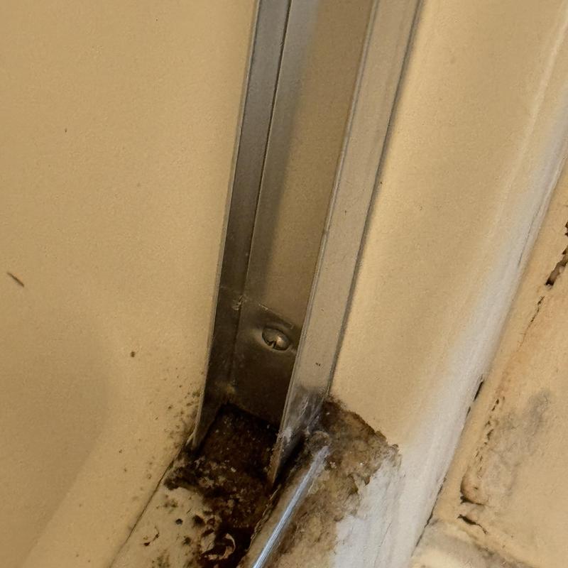 Fiberglass shower joint with mildew and damage Fiberglass shower joint with mildew and damage