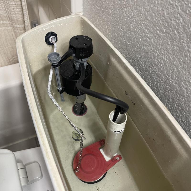 Toilet fill valve and flapper inside tank