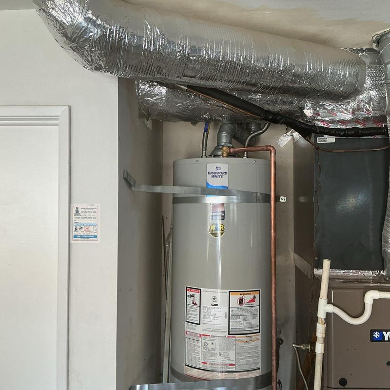 Water heater with copper piping and ductwork above