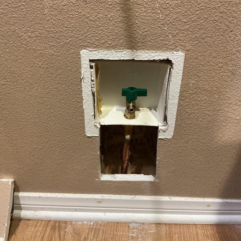 Ice maker valve with green handle in wall niche
