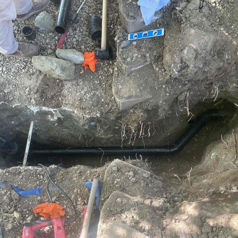 Sewer line with new piping installation in trench