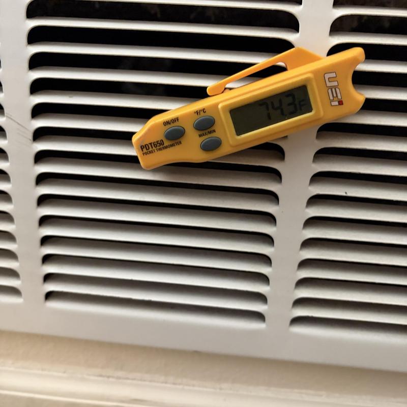 Air conditioner vent with digital thermometer reading 74.3°F Air conditioner vent with digital thermometer reading 74.3°F