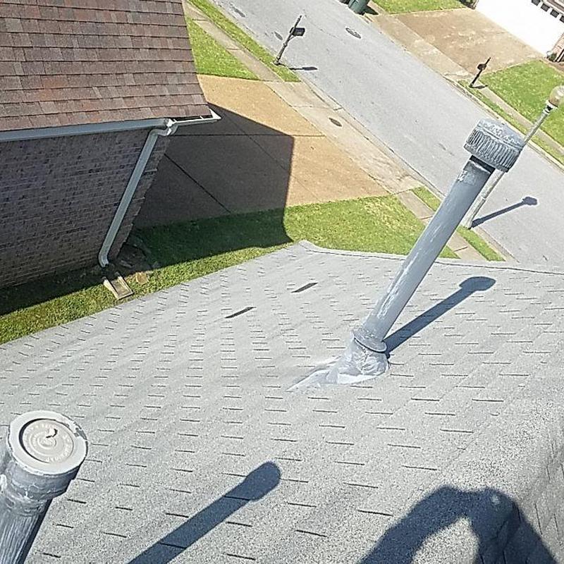 Shingle roof with vent pipes and storm damage repairs