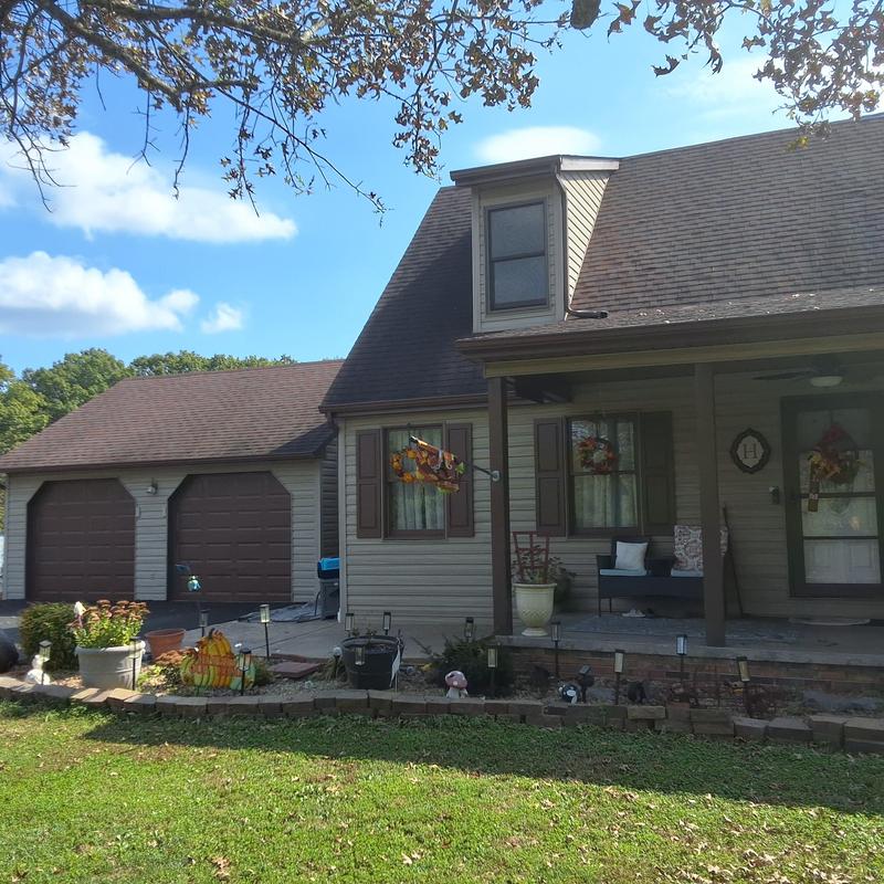 Roof with temporary tarp over leak points in Piney Flats