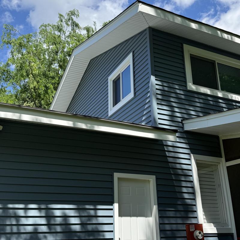 Vinyl siding and soffit installation on two-story house