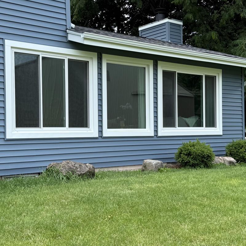 Vinyl siding and white trim window installation