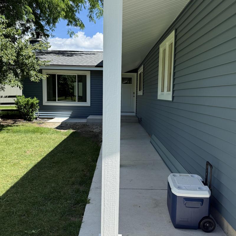 Vinyl siding installation on house exterior with windows
