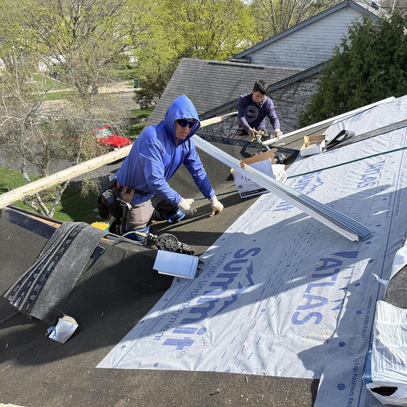 Atlas Class 4 impact asphalt roof installation workers