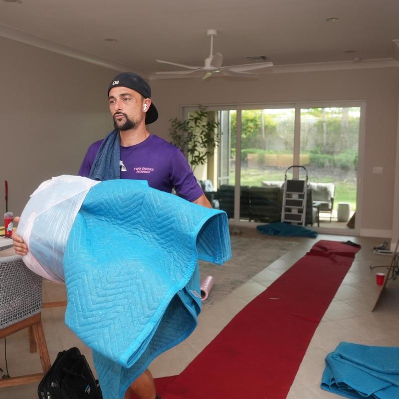 Grandfather clock wrapped for moving in living room