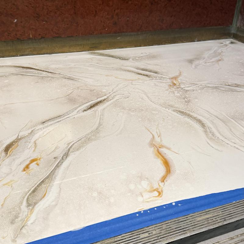 Liquid marble elevator floor with veined design
