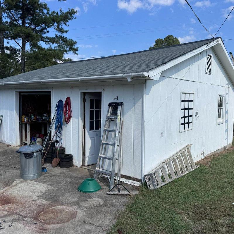 Asphalt shingle roof on detached garage with ladders Asphalt shingle roof on detached garage with ladders