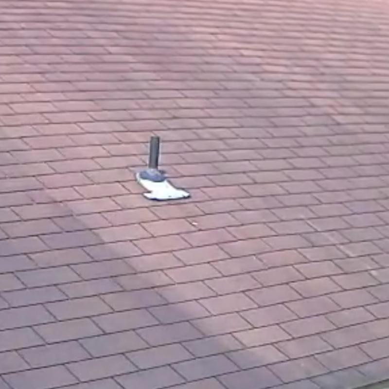 Asphalt shingle roof with pipe flashing and damage Asphalt shingle roof with pipe flashing and damage