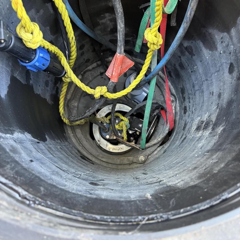 Grinder pump basin with electrical wiring and ropes Grinder pump basin with electrical wiring and ropes