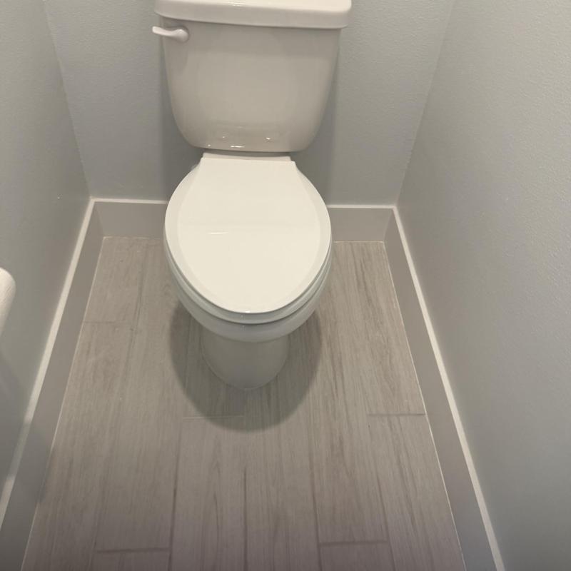 Toto toilet with slow close seat in bathroom corner