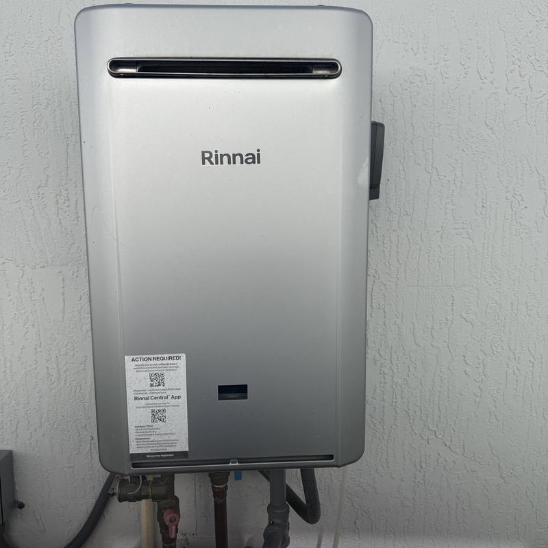 Tankless water heater unit on exterior wall