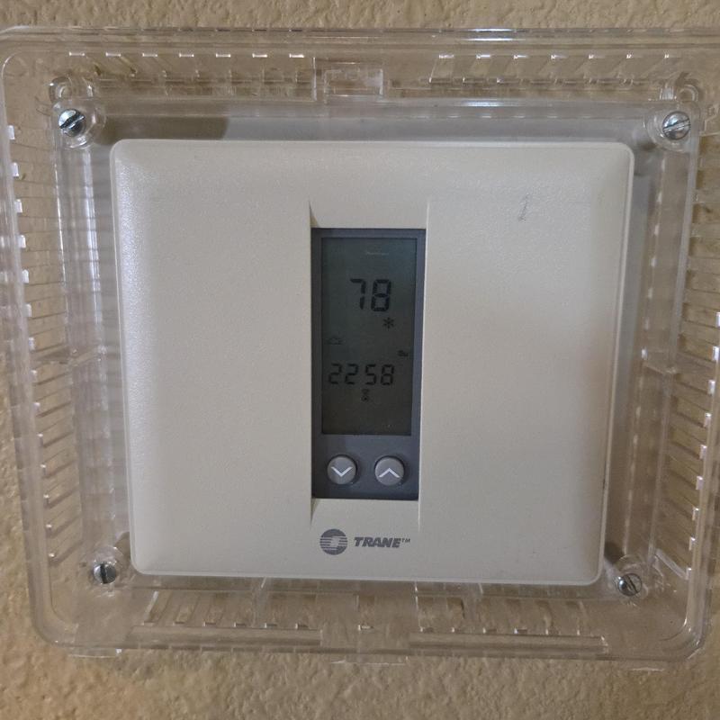 Trane thermostat with protective clear cover on wall Trane thermostat with protective clear cover on wall