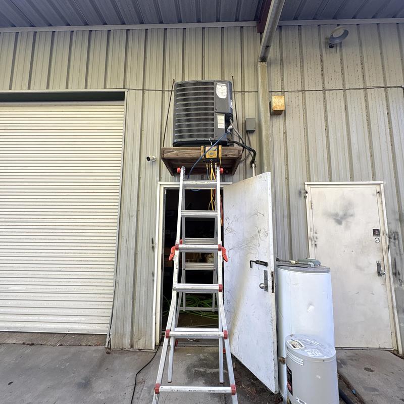 Air conditioner unit on platform with ladder setup Air conditioner unit on platform with ladder setup