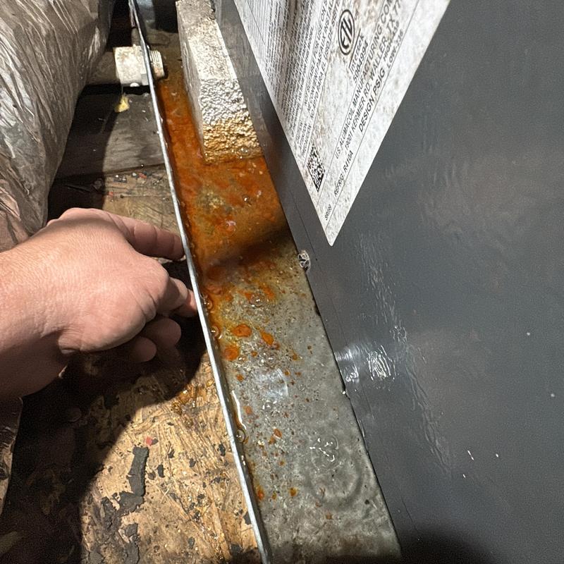 HVAC condensate drain pan with rust buildup during maintenance HVAC condensate drain pan with rust buildup during maintenance