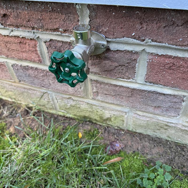 Frost proof hose bib on exterior brick wall