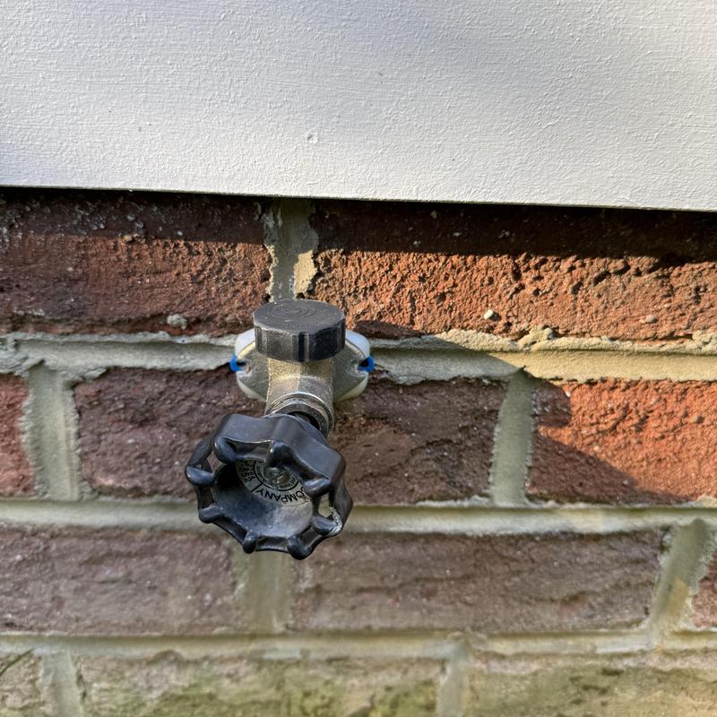 Frost proof hose bib on exterior brick wall