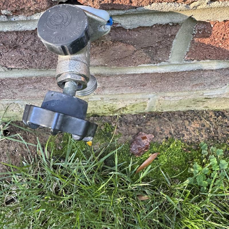 Frost proof hose bib on brick wall exterior