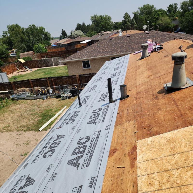 Roof underlayment installation on wooden deck Roof underlayment installation on wooden deck