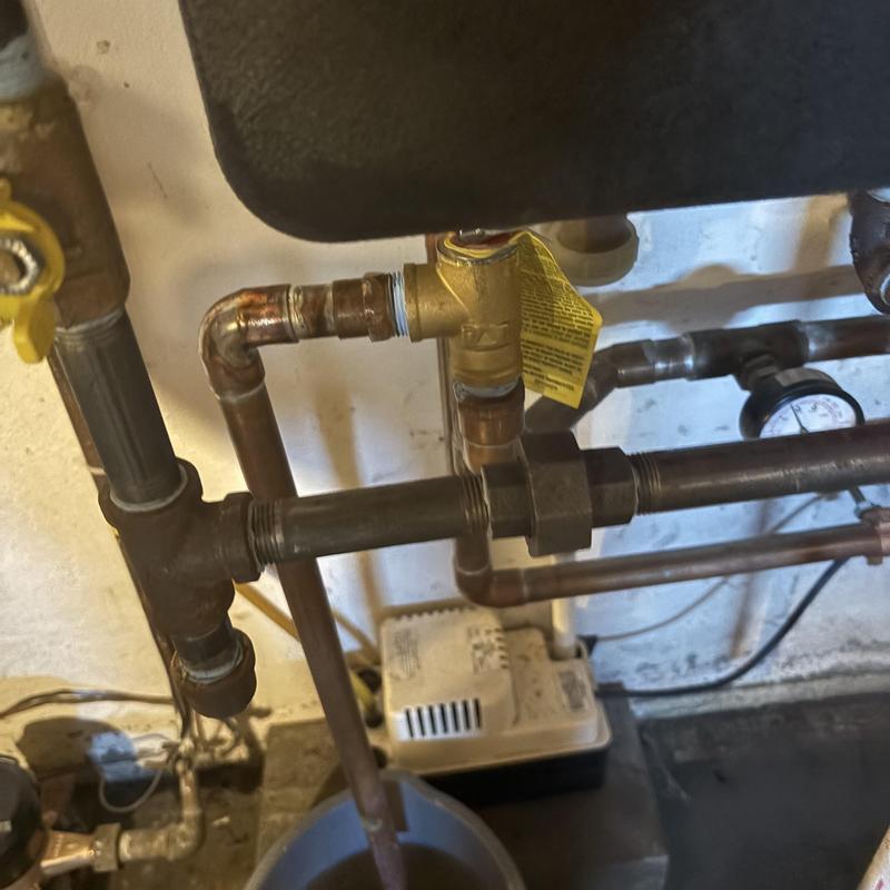 Pressure relief valve and piping with gauge in basement