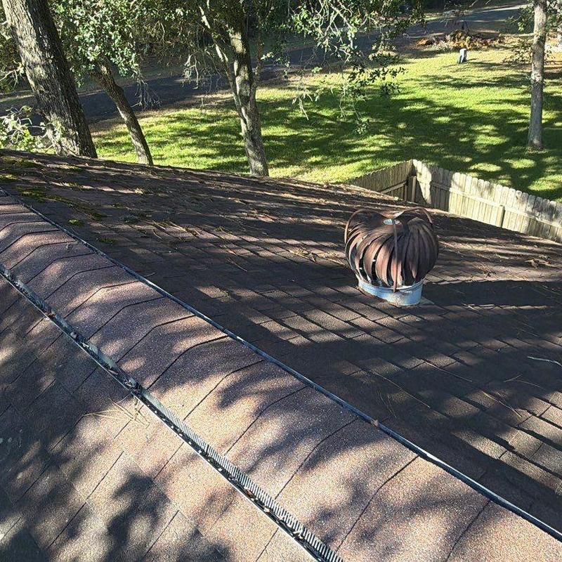 Roof shingles with turbine vent on residential roof