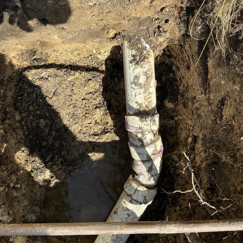 3-inch sewer pipe section with root damage in yard