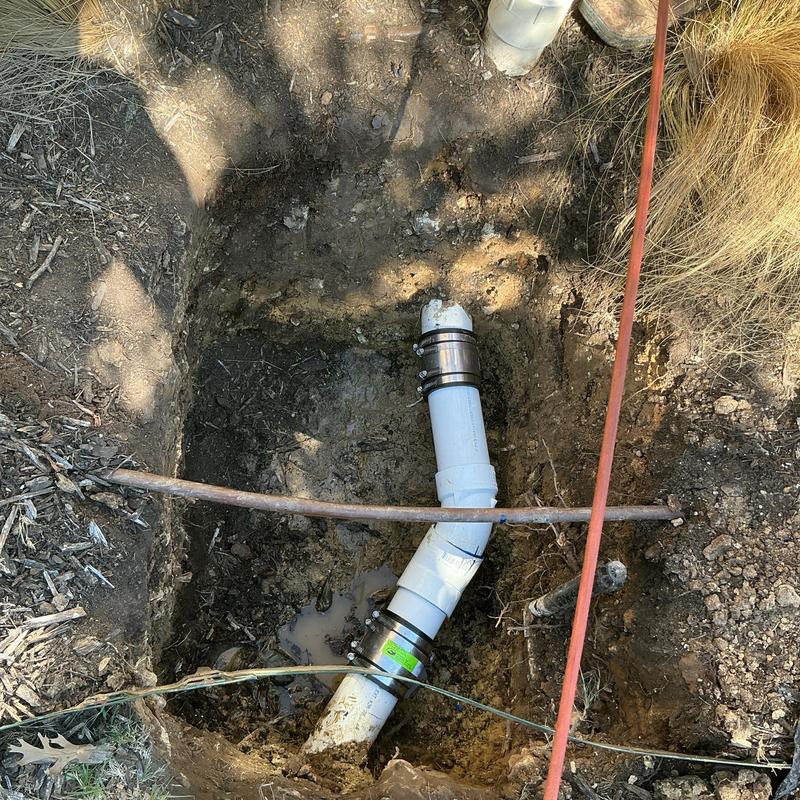 3-inch sewer pipe with new coupling in yard trench