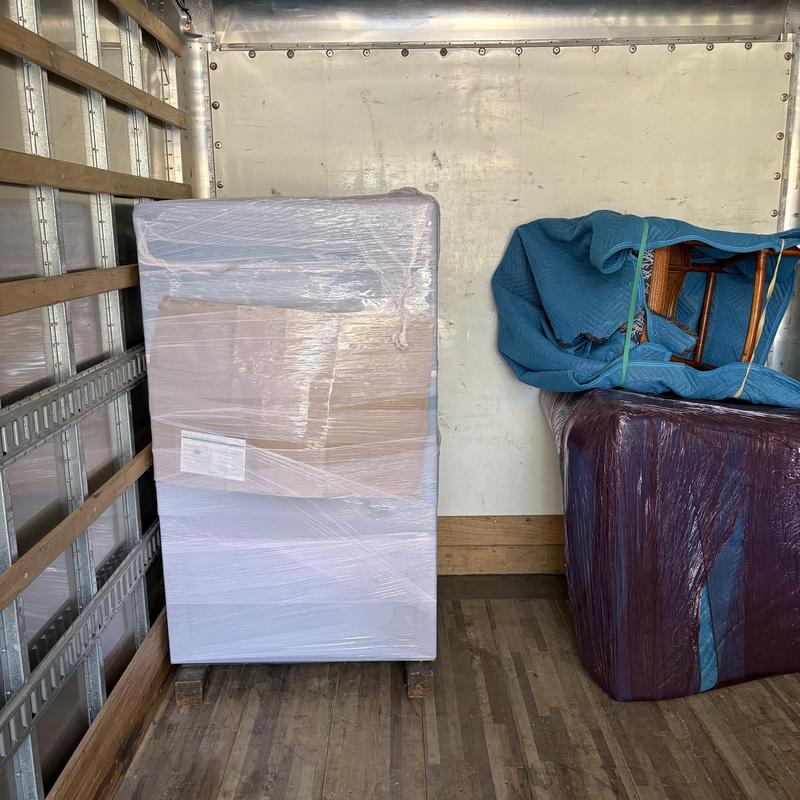 Wrapped safe and furniture inside moving truck