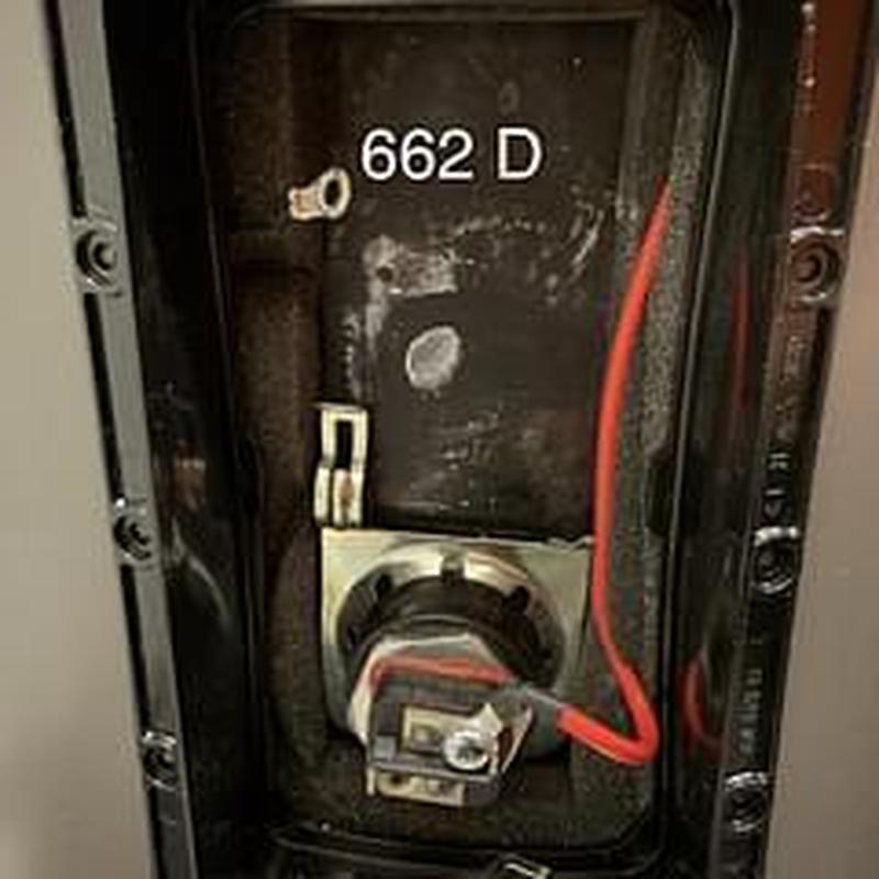 Water heater thermostat with red wiring in panel box