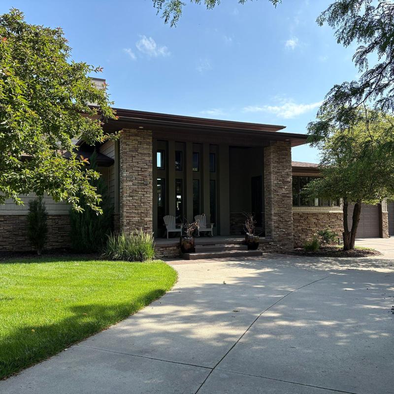 Gutters on residential stone home with front porch Gutters on residential stone home with front porch