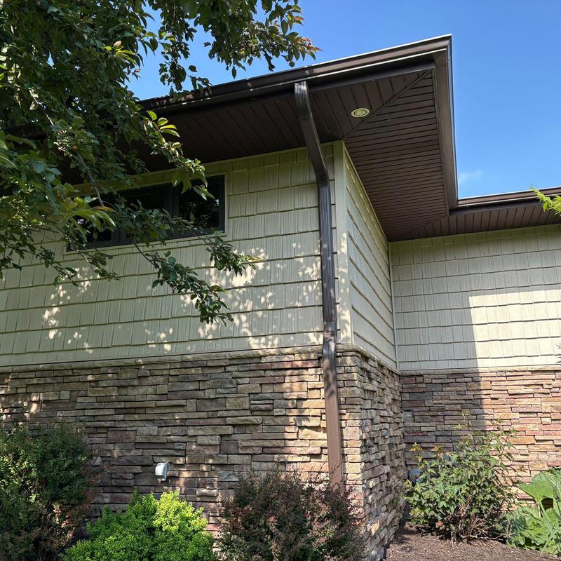 Gutter downspout and exterior siding on residential home Gutter downspout and exterior siding on residential home