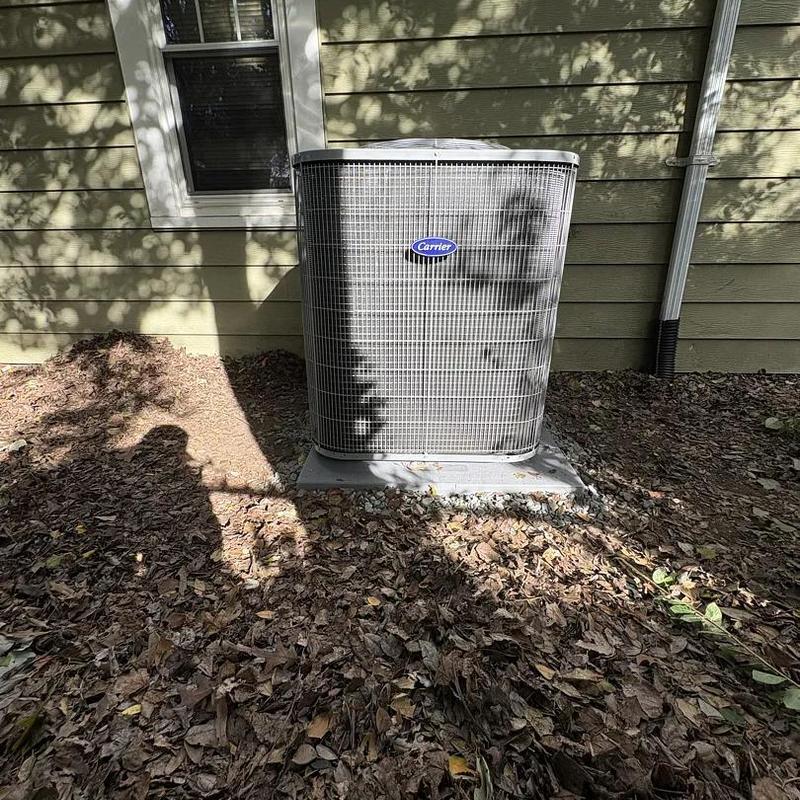 Carrier heat pump unit outside home in yard Carrier heat pump unit outside home in yard
