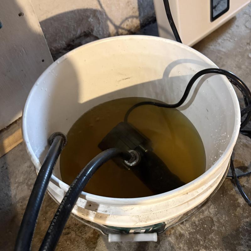 Hydronic system mineral cleaning in white bucket