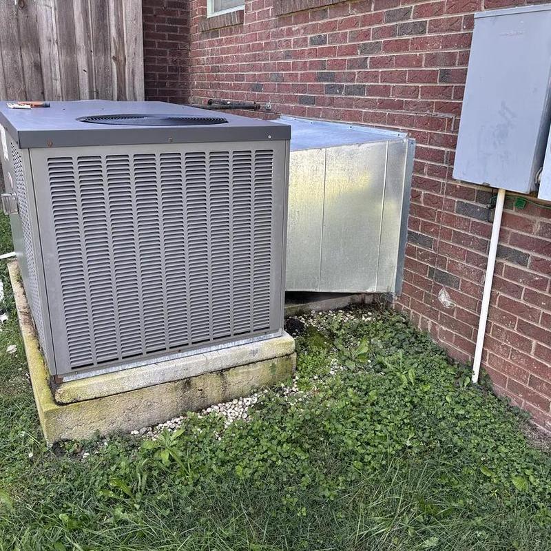 Air conditioning unit and ductwork outside brick home Air conditioning unit and ductwork outside brick home