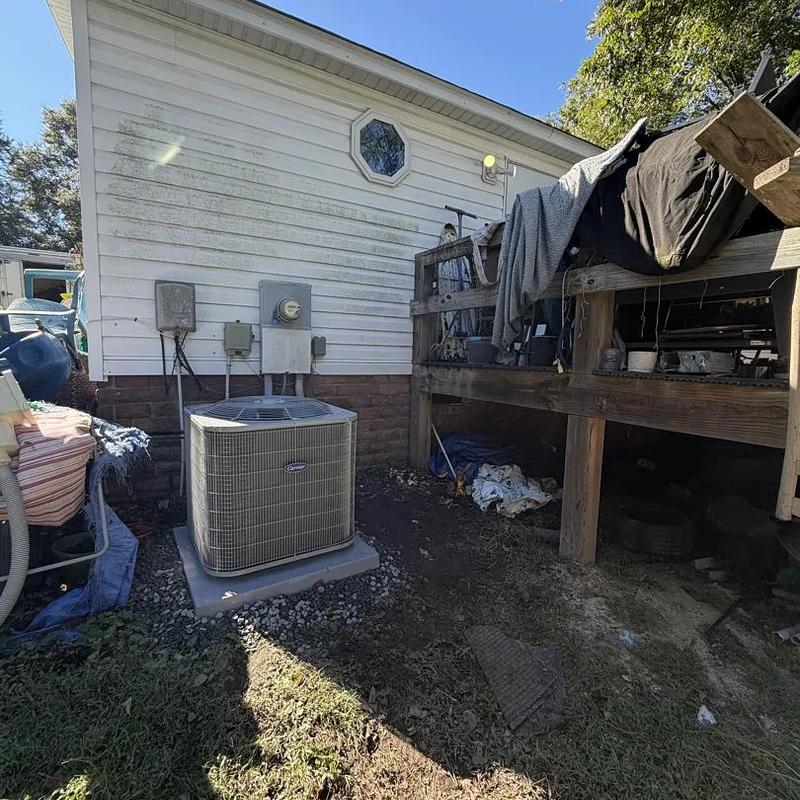 Heat pump unit outside mobile home with wooden deck nearby Heat pump unit outside mobile home with wooden deck nearby