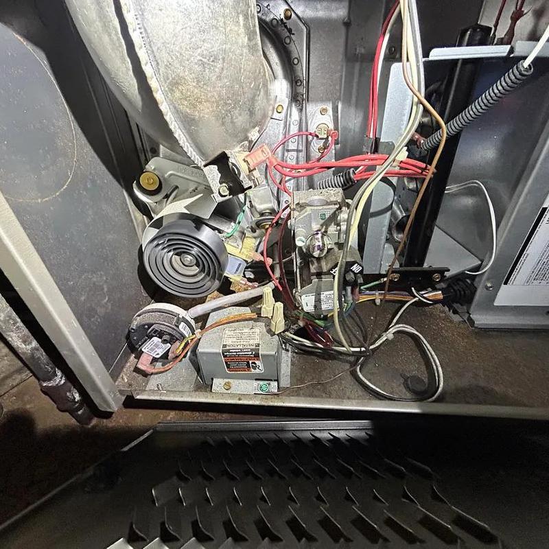 Gas furnace interior with wiring and flame sensor visible Gas furnace interior with wiring and flame sensor visible