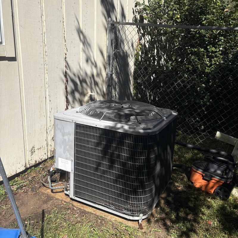 Air conditioner condenser unit outdoors with vacuum cleaning Air conditioner condenser unit outdoors with vacuum cleaning