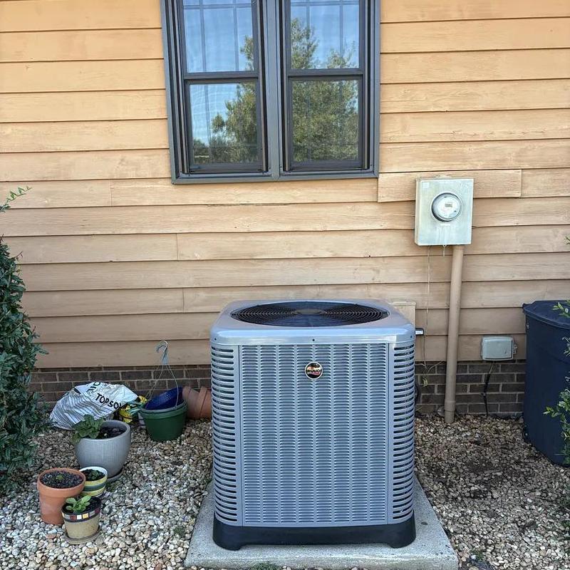 Ruud 2-stage heat pump unit outside house Ruud 2-stage heat pump unit outside house