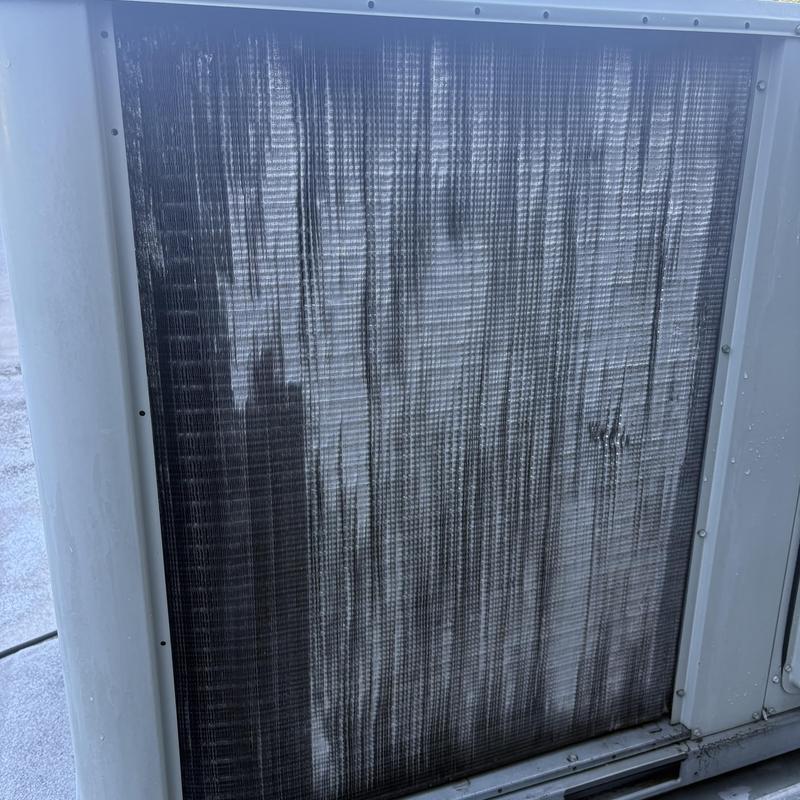 Condenser coil on rooftop unit with straightened fins Condenser coil on rooftop unit with straightened fins