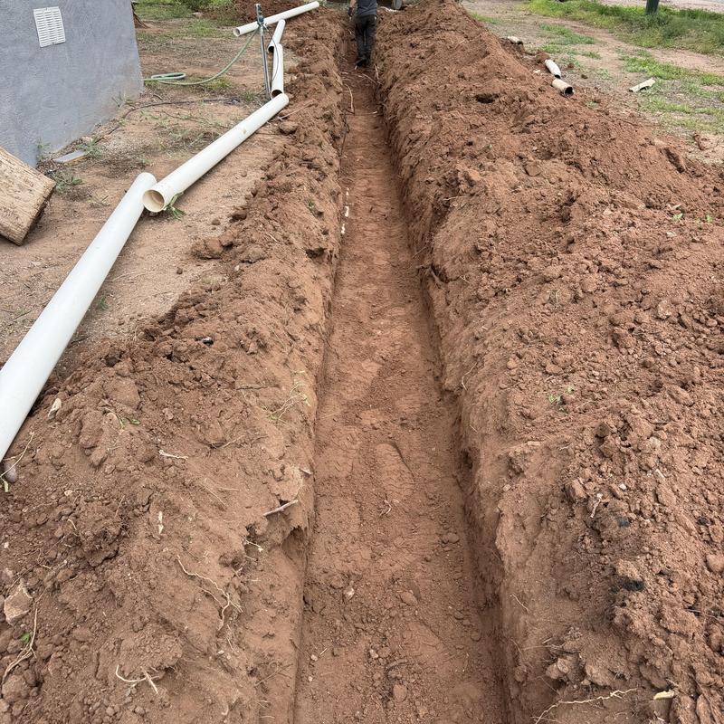 Main sewer line trench with PVC pipe sections Main sewer line trench with PVC pipe sections
