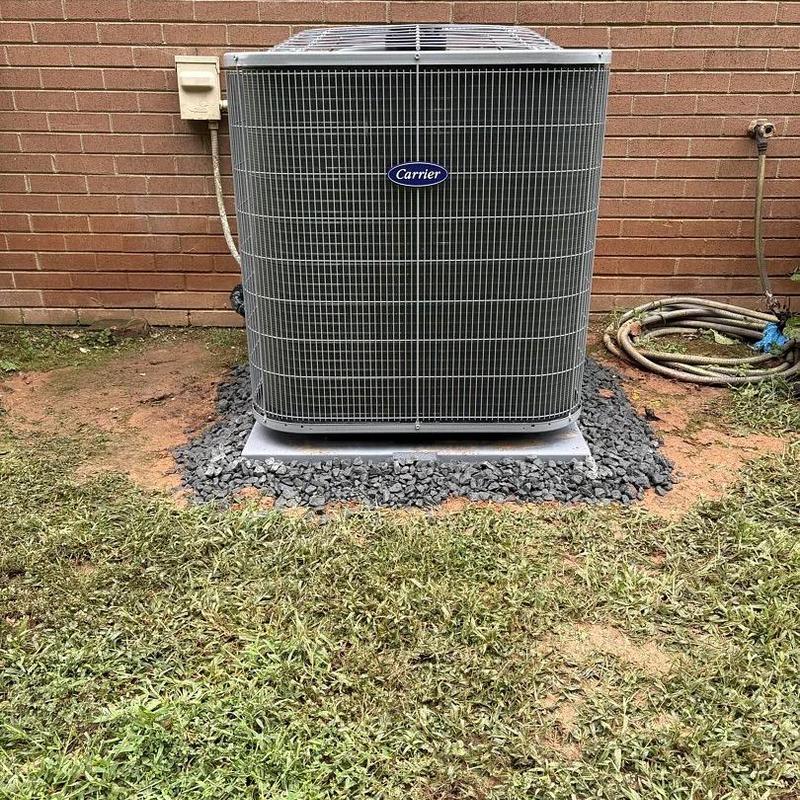 Carrier heat pump unit installed on stone bed outdoors Carrier heat pump unit installed on stone bed outdoors