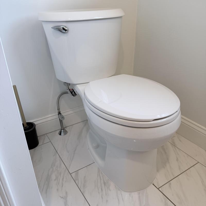 Toilet with fresh water line and flange reset in bathroom