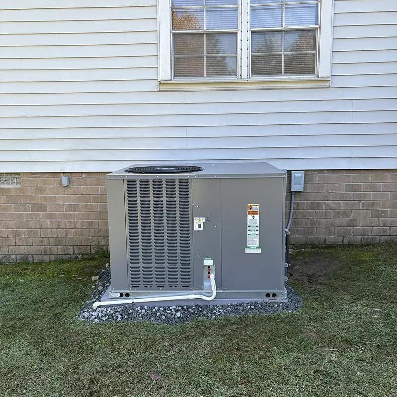 Ruud package heat pump installed outside home Ruud package heat pump installed outside home